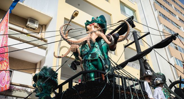 Loule, Portugal - February 25, 2020: Pirate ship float parading in the street in front of the public in the parade of the traditional carnival of Loule city on a February day