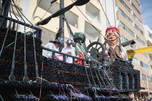 Loule, Portugal - February 25, 2020: Pirate ship float parading in the street in front of the public in the parade of the traditional carnival of Loule city on a February day