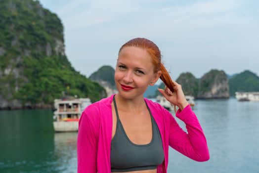 Tourist enjoying landscape with limestone mountains. Ha Long Bay, Vietnam