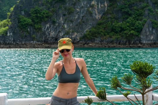 Tourist enjoying landscape with limestone mountains. Ha Long Bay, Vietnam