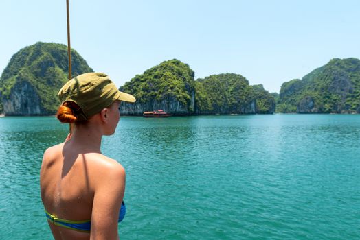 Tourist enjoying landscape with limestone mountains. Ha Long Bay, Vietnam