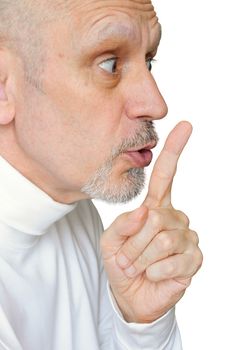 Man intimating silence, making "hush!" with the finger in front of the lips