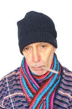 Sick man with the flu and temperature, wearing a cap and a woolen scarf, on white background