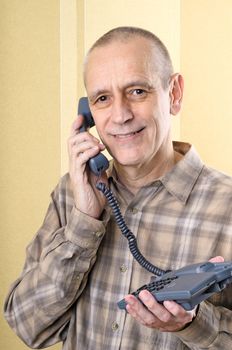 Bright man smiling while speaking on phone