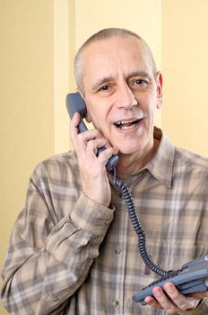 Handsome man speaking softly with a friend on the phone