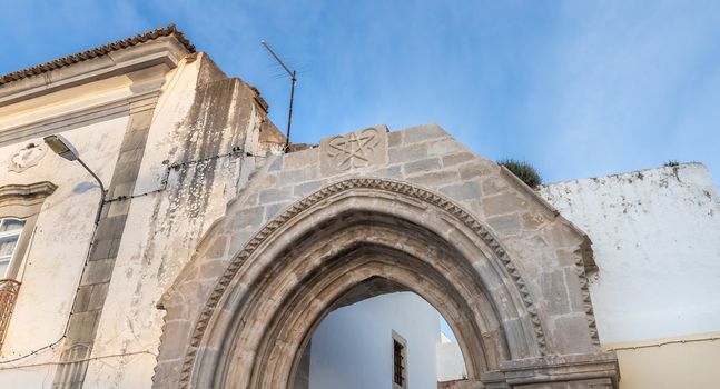 Loule, Faro, Portugal - February 25, 2020: architectural detail of the remains of the door of the old monastery of Saint Francis (Convento da Graça) in the historic city center on a winter day