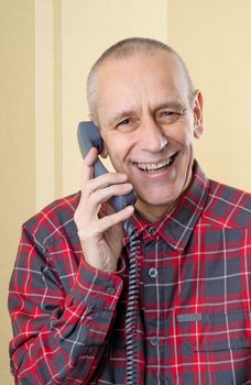 Happy man laughing and speaking with a friend on phone