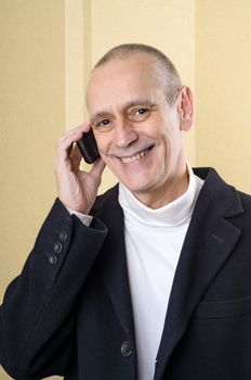 Smiling businessman speaking on mobile phone