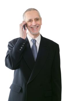 An amicable businessman smiling on mobile phone