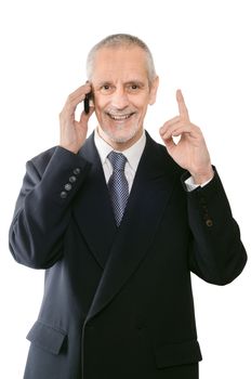 A pleasant businessman smiling on mobile phone and showing the forefinger