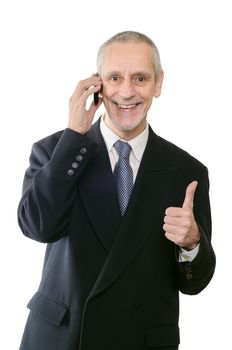 An amiable businessman smiling on mobile phone, with thumb up