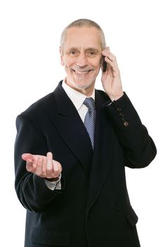 An agreeable businessman smiling on mobile phone