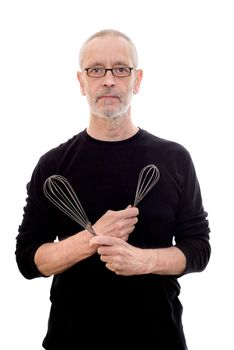 Adult man in black wearing glasses holds a whip in each hand and looks serious