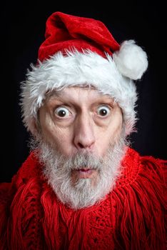 Portrait of an adult man with white beard disguised in Santa Claus for the Christmas Holiday