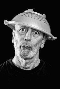 Dramatic black and white Portrait of a mad man with a plastic strainer on the head