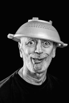 Dramatic black and white Portrait of a mad man with a plastic strainer on the head