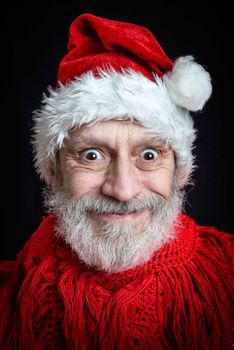 Portrait of an adult man with white beard disguised in Santa Claus for the Christmas Holiday