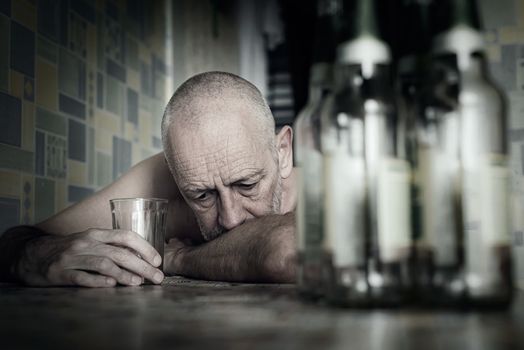 A desperate man falls into depression and becomes alcoholic and miserable. His addiction leads him to a state of loneliness and poverty. He has no hope and could be suicidal.