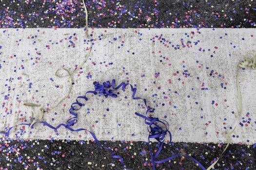 pile of confetti and paper streamer on the bitumen during a carnival