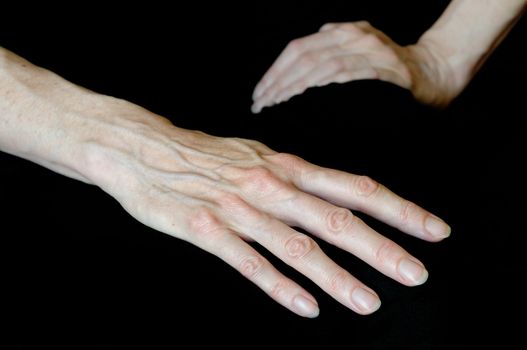 Different positions of senior woman's hands on black background