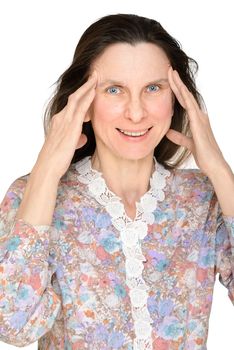 A smiling mature woman puts the fingers on the temple to show that she is thinking about something important