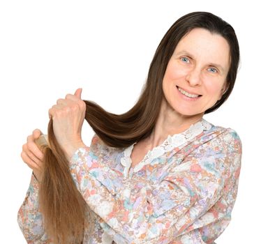 Adult woman combing long brown hair with a wooden comb, isolated on white background