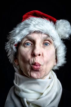 Portrait of a kissing adult woman disguised in Santa Claus for the Christmas Holiday