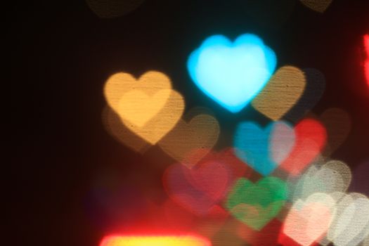 colorful heart-shaped on black background, lighting bokeh for wallpaper, blurred bokeh for valentine's day background, love pictures background, lighting heart shape soft at night time