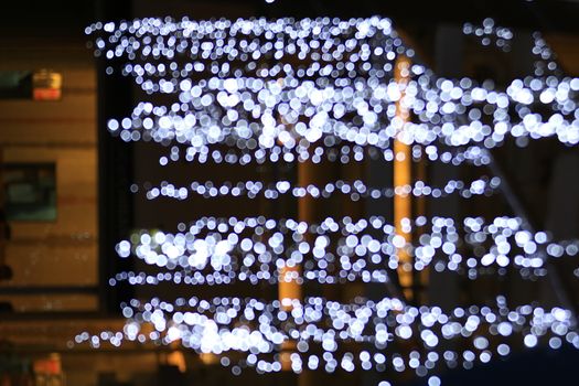 Light line blurred bokeh background, Night lights decorated restaurant, Light for decoration department store in merry Christmas and happy New Years festival, lifestyle night lighting bokeh