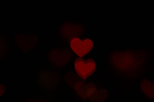 Valentine Red heart-shaped on black background Colorful lighting bokeh for decoration at night backdrop wallpaper blurred valentine, Love background, Lighting heart shaped soft night abstract