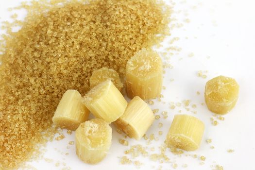 Sugar heap and sugarcane cut, Cane, piece of sugarcane cut and Sugar cane, Granulated sugar on white background
