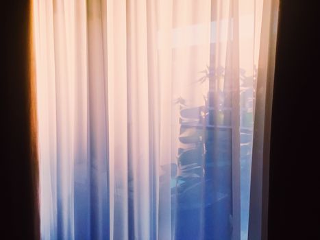 Curtains on window at sunset, furniture and design