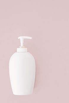 Bottle of antibacterial liquid soap and hand sanitizer on beige background, hygiene product and health care concept