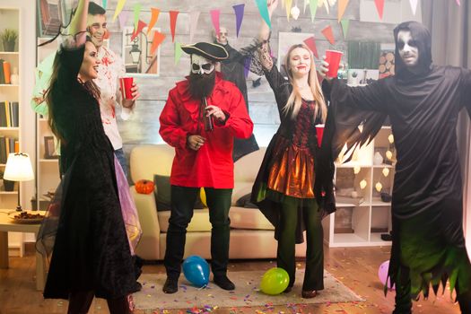 Young man dressed up like a pirate at a halloween party with his friends.