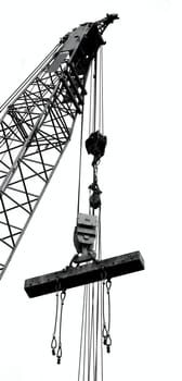 Outline silhouette of a large crane lifting a solid steel girder
