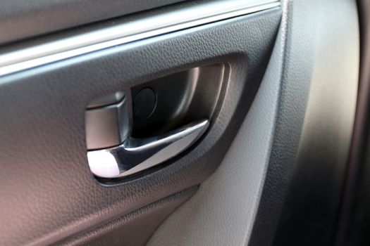 door handle of car and central locking, inside the car door handle with central locking buttons (selective focus)