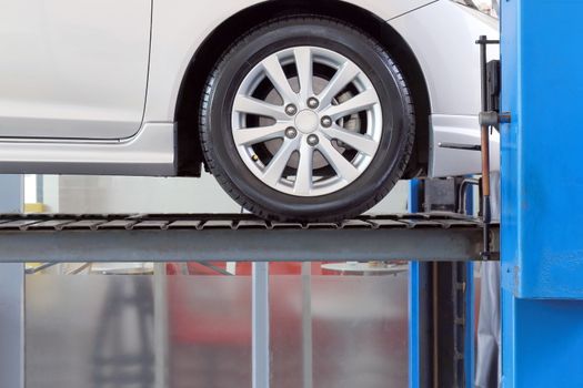 car on service garage with mechanical tools for car under repair, auto mechanic working in car service centre