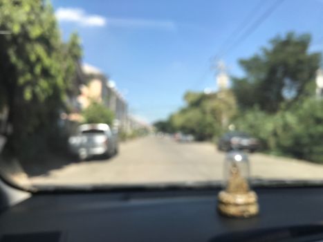 Blurred picture Road Soi village background in city Thai, From inside car view