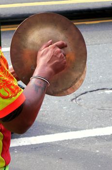 -- a man is using traditional brass cymbals