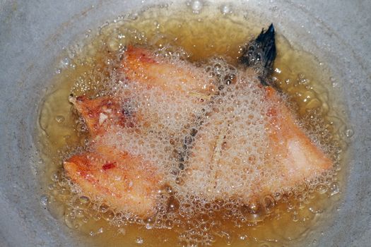 Fried fish pieces in hot oil pan, Fried fish for diet, Fish cutting Portion slice fried in oil cooking pan is food protein diet health
