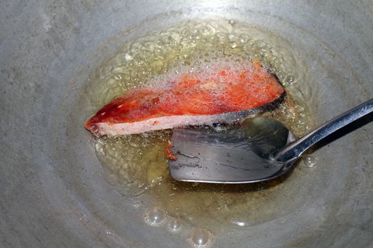 Fried fish pieces in hot oil pan, Fried fish for diet, Fish cutting Portion slice fried in oil cooking pan is food protein diet health