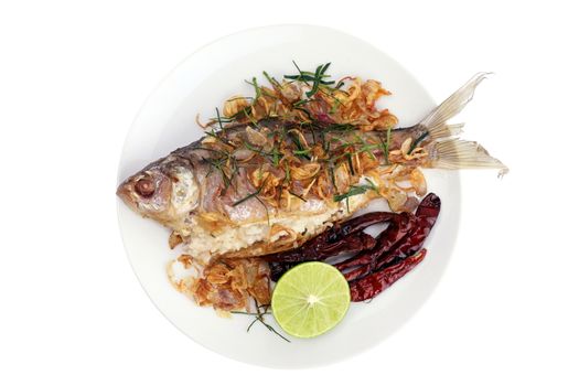 pickled fish tasty fried (pla som tod : thai word), pickled fish fry and fried onion, lime slice, and fried chili served with fresh vegetable on white background