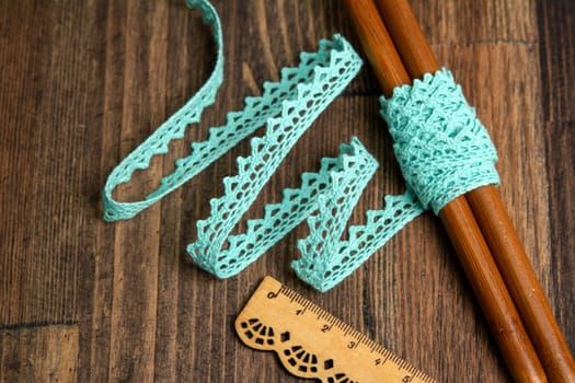 knitted emerald openwork linen ribbon tapes in rural style of rustics cotton eco natural on wood ground