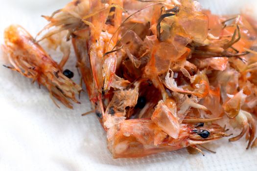 pile of cooked and peeled shrimp, waste food shrimp peeled, detail of the heads and eyes of this seafood, wastes from cleaning cooked shrimps (Selective Focus)