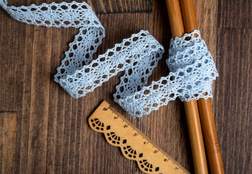 knitted blue openwork linen ribbon tapes in rural style of rustics cotton eco natural on wood ground