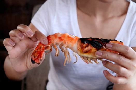 Hand are holding shrimp big size, Shrimp grill in hand, Seafood Prawn dinner, Cooked grilled shrimp or eating shrimp peeled