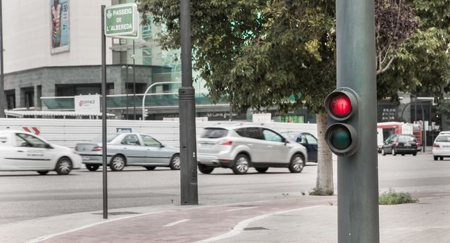 Valencia, Spain - June 16, 2017: Red traffic light in a traffic jam in the center where cars are at the city stop on a summer day