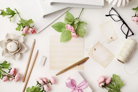 workspace with office tools and empty paper letters on white background. Flat lay, top view office table desk.  