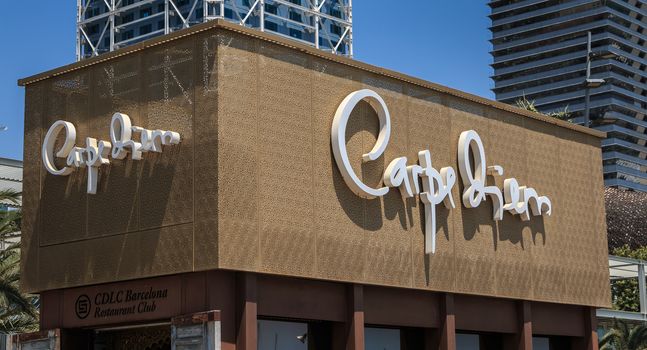 Barcelona, Spain - June 21, 2017: View of the sign of the luxury restaurant CarpeDiem in the city harbor on a summer day