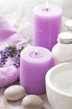 SPA still life. lavender flowers, pebbles, aromatherapy candle, essential oil and bath products